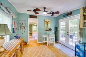 a bedroom with blue walls and a ceiling fan at Cozy Fort Pierce Cottage on Farm Animal Rescue! in Fort Pierce