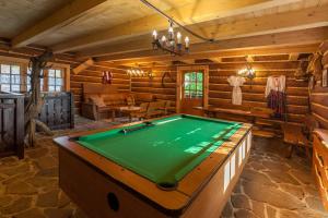 a pool table in a room in a log cabin at Pokoje Gościnne Ino Zajrzyj in Ustroń