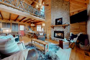 a living room with a fireplace in a log cabin at Moonshine Overlook in Blue Ridge