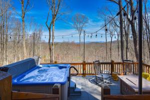 a hot tub on a deck with a table and chairs at Moonshine Overlook in Blue Ridge