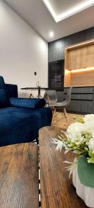 a living room with a blue couch and a table at Apartmán Porte in Košice