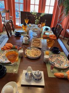 a wooden table with plates of food on it at My Rosegarden Guest Rooms in San Francisco