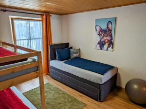 een slaapkamer met een bed en een hondenverf aan de muur bij Ferienwohnung Alpenblick Dorner in Oberreute