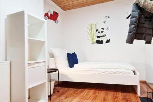 biała sypialnia z łóżkiem i półką na książki w obiekcie Große, geräumige Unterkunft für bis zu 13 Personen! w Lipsku