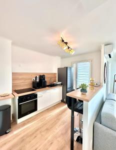 a kitchen with a counter and a table in a room at Magnifique appartement en face du stade Vélodrome in Marseille