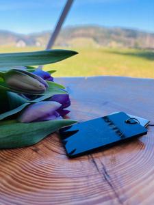 a card sitting on top of a table with tulips at Silence Glamp - Glamping Bieszczady in Ustrzyki Dolne