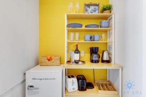 a kitchen with yellow walls and a white refrigerator at Modern Condo - Amazing Pool - Gym - Balcony in Hallandale Beach