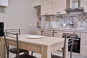 a kitchen with a wooden table and chairs at Cristina Tuscany Holiday in Poggibonsi