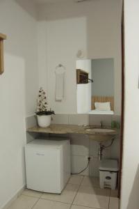 a small bathroom with a sink and a counter at Hotel Serras De Goyaz Bueno, Goiânia in Goiânia