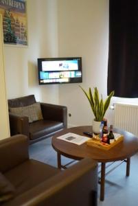 a living room with a coffee table and a tv at Arku apartments Brussels Airport in Zaventem