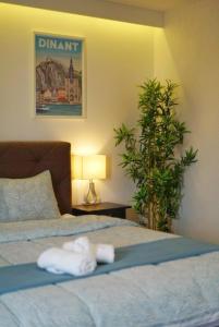 a hotel room with two towels on a bed at Arku apartments Brussels Airport in Zaventem