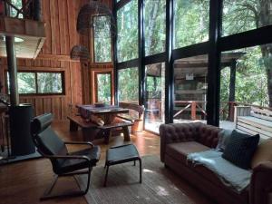 a living room with a couch and a table at El Refugio de Hadas y Elfos in Puerto Fuy