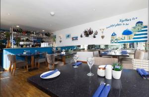 a dining room with a table and chairs and a restaurant at De L'Etang in Saint Helier Jersey