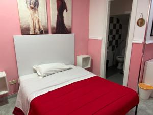 a bedroom with a bed with a red blanket at Hotel Alloggio Del Conte in Naples