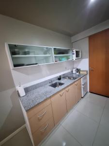 a kitchen with a sink and a counter at Palermo Soho in Buenos Aires