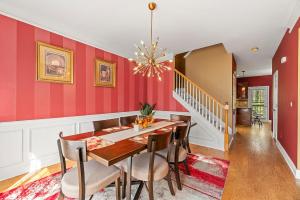 a dining room with red walls and a table and chairs at Lovely Big House with an office in Atlanta, Close to the Airport in Atlanta