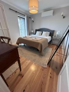a bedroom with a bed and a piano at Castas do Douro in Tabuaço +29 photos