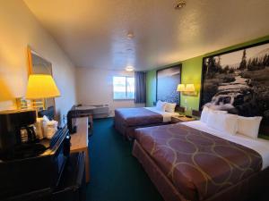 um quarto de hotel com duas camas e uma televisão em Horizon Hotel em Vernal