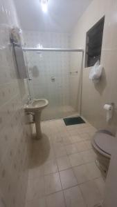 a bathroom with a shower and a sink and a toilet at Apartamento em peruibe in Peruíbe