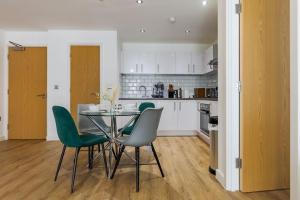 a kitchen with a dining table and green chairs at Casa Sage - Comfy - Quiet - Home Away From Home in Birmingham +13 photos