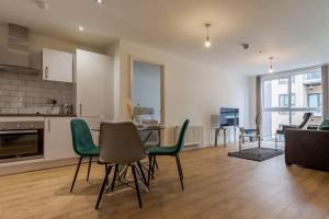 a kitchen and living room with a table and chairs at Comfy • Quiet • Your Other Home in Birmingham