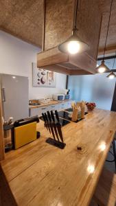 a large wooden table in a room with a kitchen at SLEEP Shop CARNAXIDE in Carnaxide