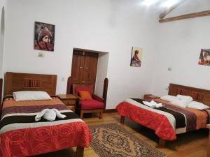 A bed or beds in a room at Casa San Pedro Cusco