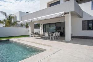 a villa with a swimming pool and a house at VILLA caracolillo MAR in Chiclana de la Frontera