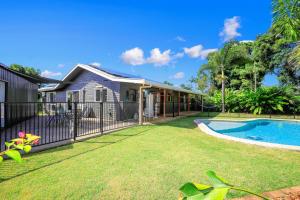 a house with a swimming pool in a yard at The Hideaway in Bargara
