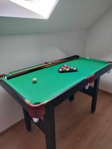 a green pool table with a ball on it at Chalúpka Mischel in Raková