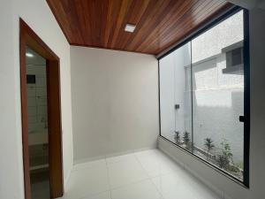 a room with a large window and white walls at Cama & Café Parecis in Campo Novo do Parecis