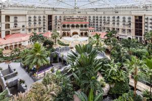 een overdekte binnenplaats van een groot gebouw met palmbomen bij Gaylord Palms Resort & Convention Center in Orlando