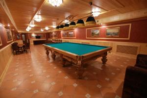 
a large room with a large wooden table and chairs at Hotel Muravskiy Trakt in Zhdanov
