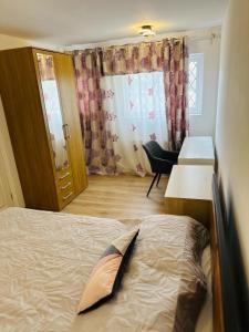 a bedroom with a bed and a desk and a window at Manchester City Centre Town House in Manchester