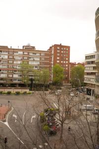 a parking lot in a city with tall buildings at Bernabéu Loft Moderno in Madrid