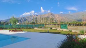 una piscina in un giardino con montagne sullo sfondo di Alpine View Chalet Cafayate a Cafayate