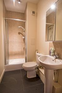 a bathroom with a toilet and a sink and a shower at The Ice House in Edinburgh