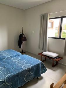 um quarto com uma cama azul e uma janela em Casa de Campo em Bananeiras-PB em Bananeiras