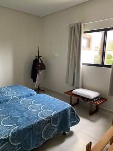 a bedroom with a blue bed and a window at Casa de Campo em Bananeiras-PB in Bananeiras
