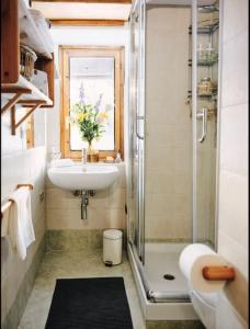 a bathroom with a sink and a shower at Cozy Chalet next to the Dora Baltea river in Villaret