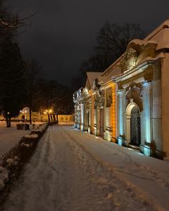 a building is covered in snow at night at Miniapartament Jelonka in Jelenia Góra