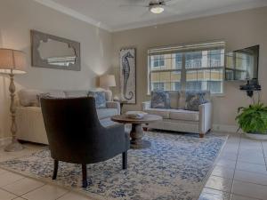 a living room with a couch and a table at 511 Regal Beach Club - Heart of Seven Mile in George Town