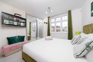 a bedroom with a large white bed and a mirror at Barking Haven Retreat - Airport - Parking - Train Station in Barking