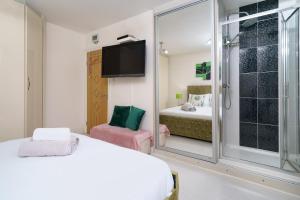 a bedroom with a bed and a sliding glass door at Barking Haven Retreat - Airport - Parking - Train Station in Barking