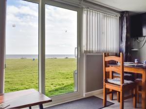 a room with a desk and a window with a view of a field at Beach View in Kessingland