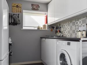 a laundry room with a washer and dryer at Beach View in Kessingland