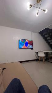 a room with a flat screen tv on a wall at Orilla Transient 1 in Mabalacat