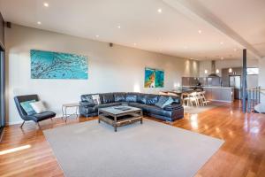 a living room with a couch and a table at Regency Beach Club in Dunsborough