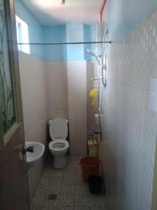 a small bathroom with a toilet and a sink at ARSIAM Transient Room in Baguio