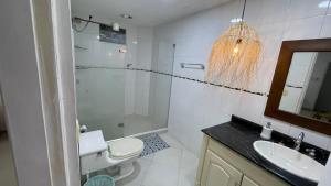 a bathroom with a toilet and a sink and a shower at Casa Maria campestre con piscina in Santa Marta
